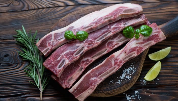 Raw fresh short beef ribs for grill, rustic wooden setting